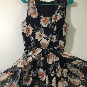 Navy blue Floral jumpsuit with skirt attached.